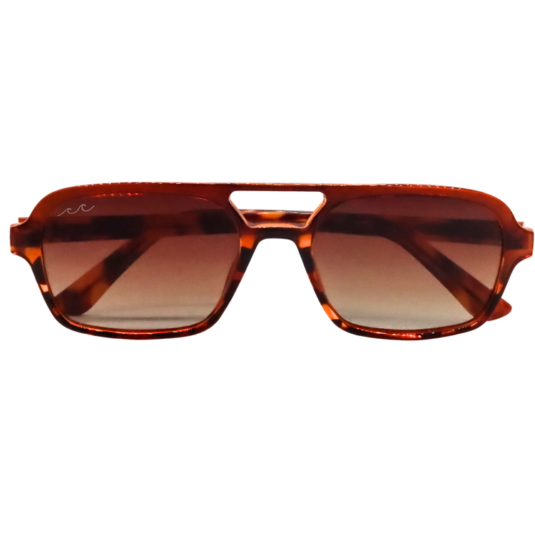 A pair of aviator-style sunglasses with a translucent amber-brown tortoiseshell frame and gradient brown lenses, shown against a plain white background.